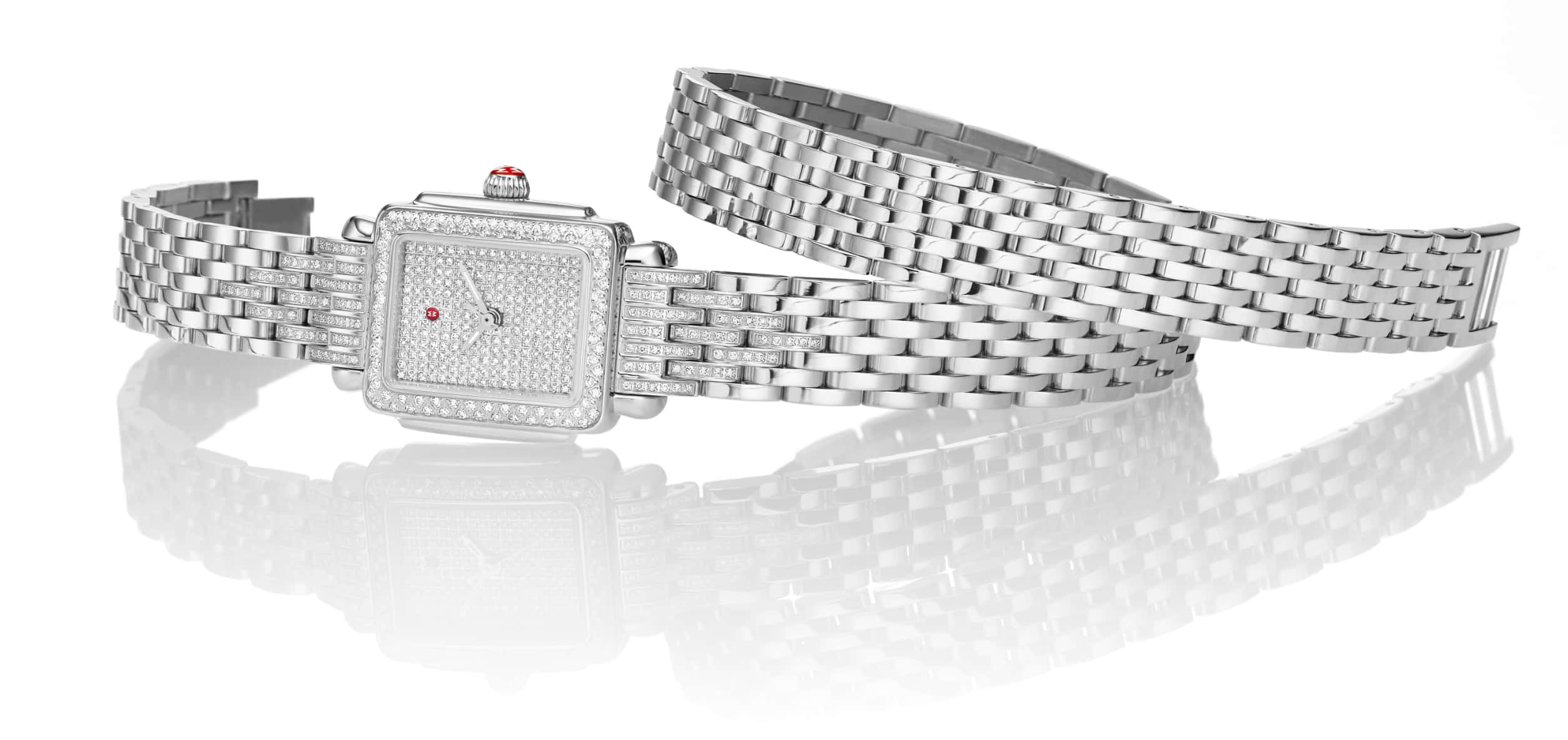 Limited-edition Deco watch featuring diamond-covered dial and emerald indexes.
