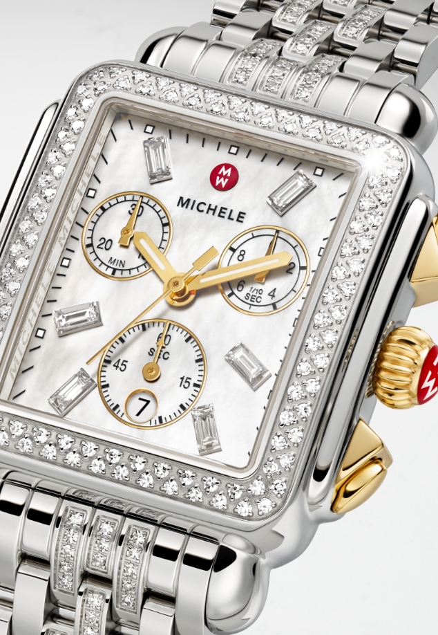 Detail shot of a MICHELE watch head featuring a diamond bezel and diamond indexes.