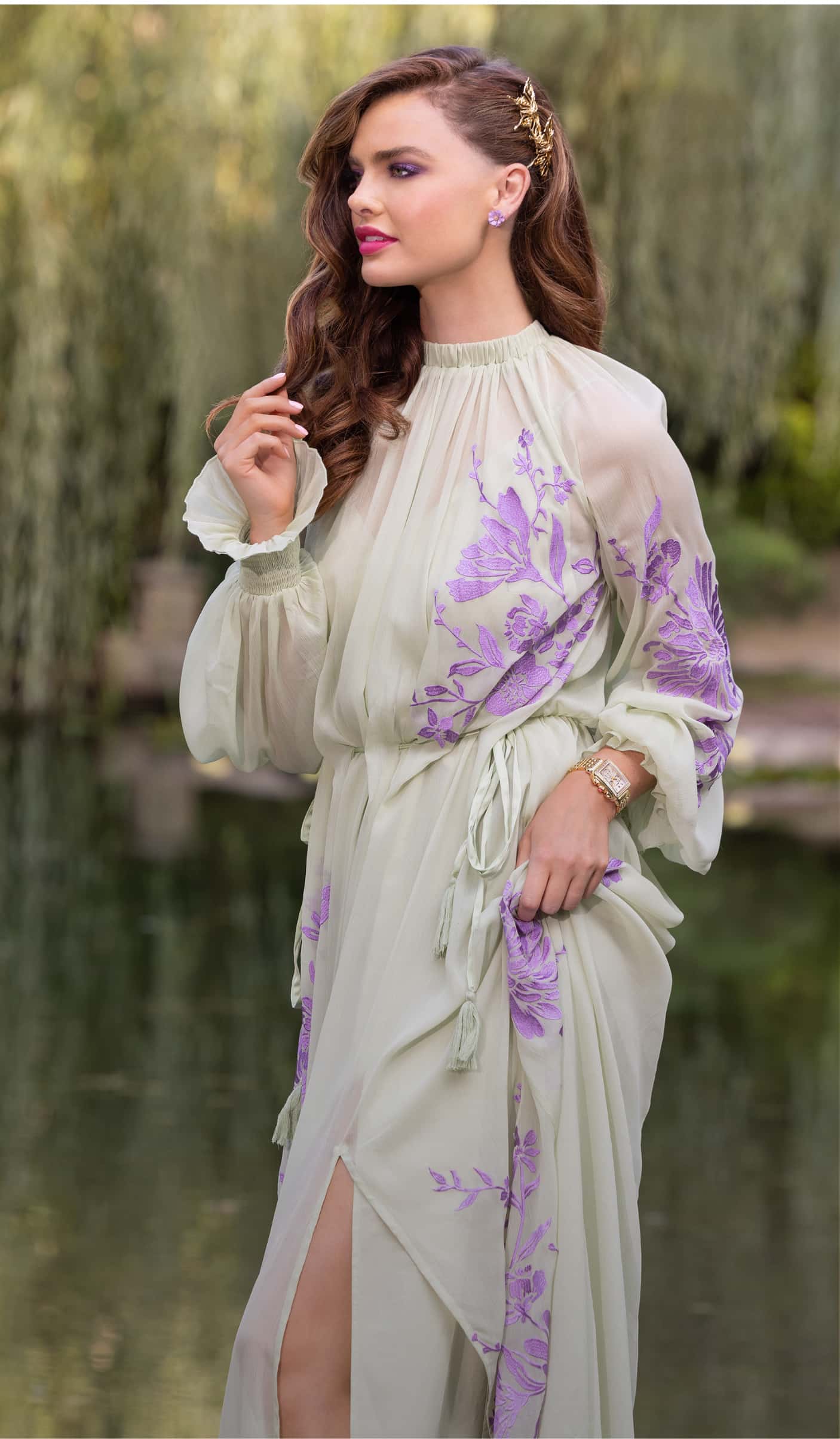 Woman in a green and purple floral gown.