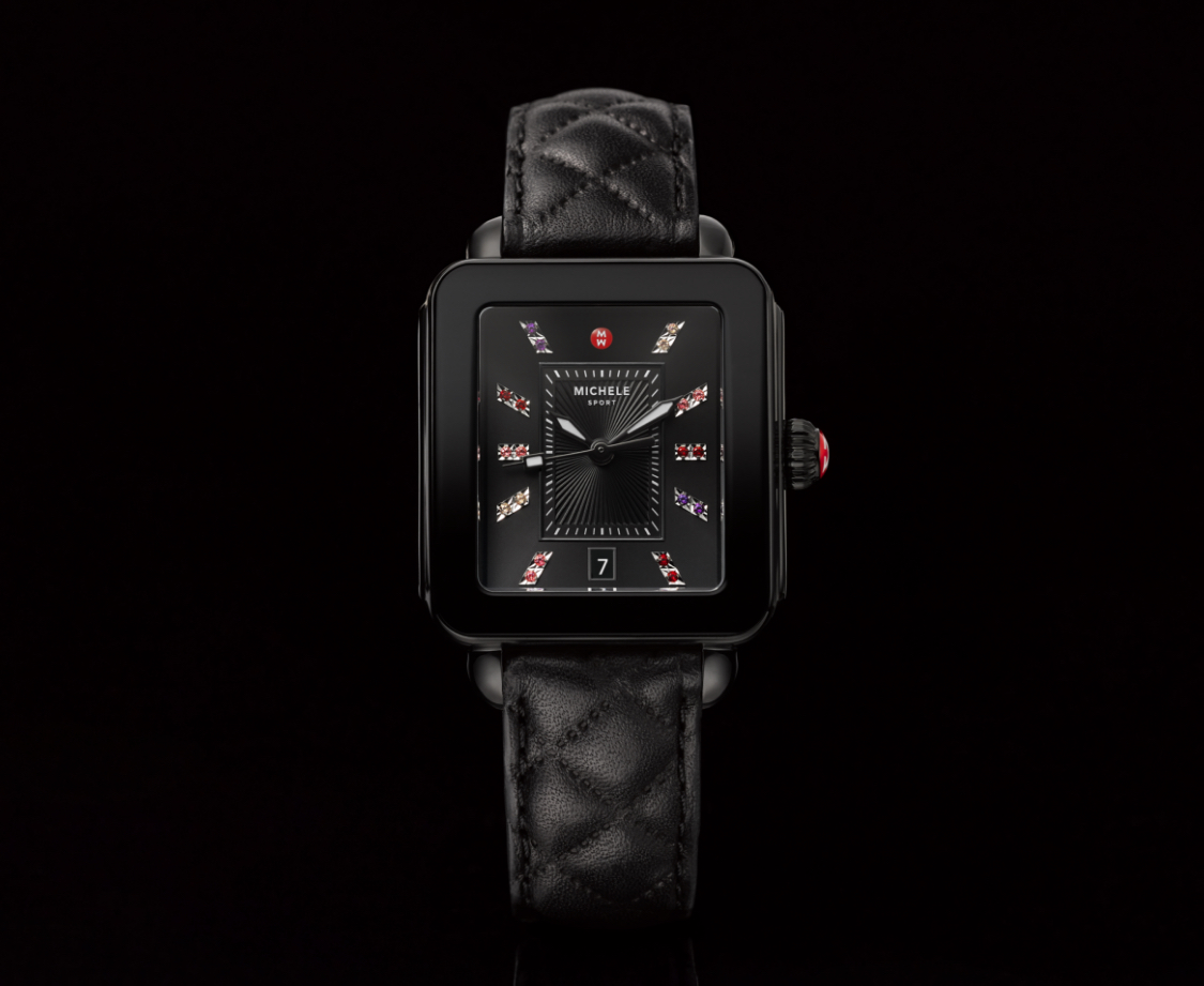 Deco sport watch featuring a rainbow of topaz indexes, black quilted leather strap and black dial.