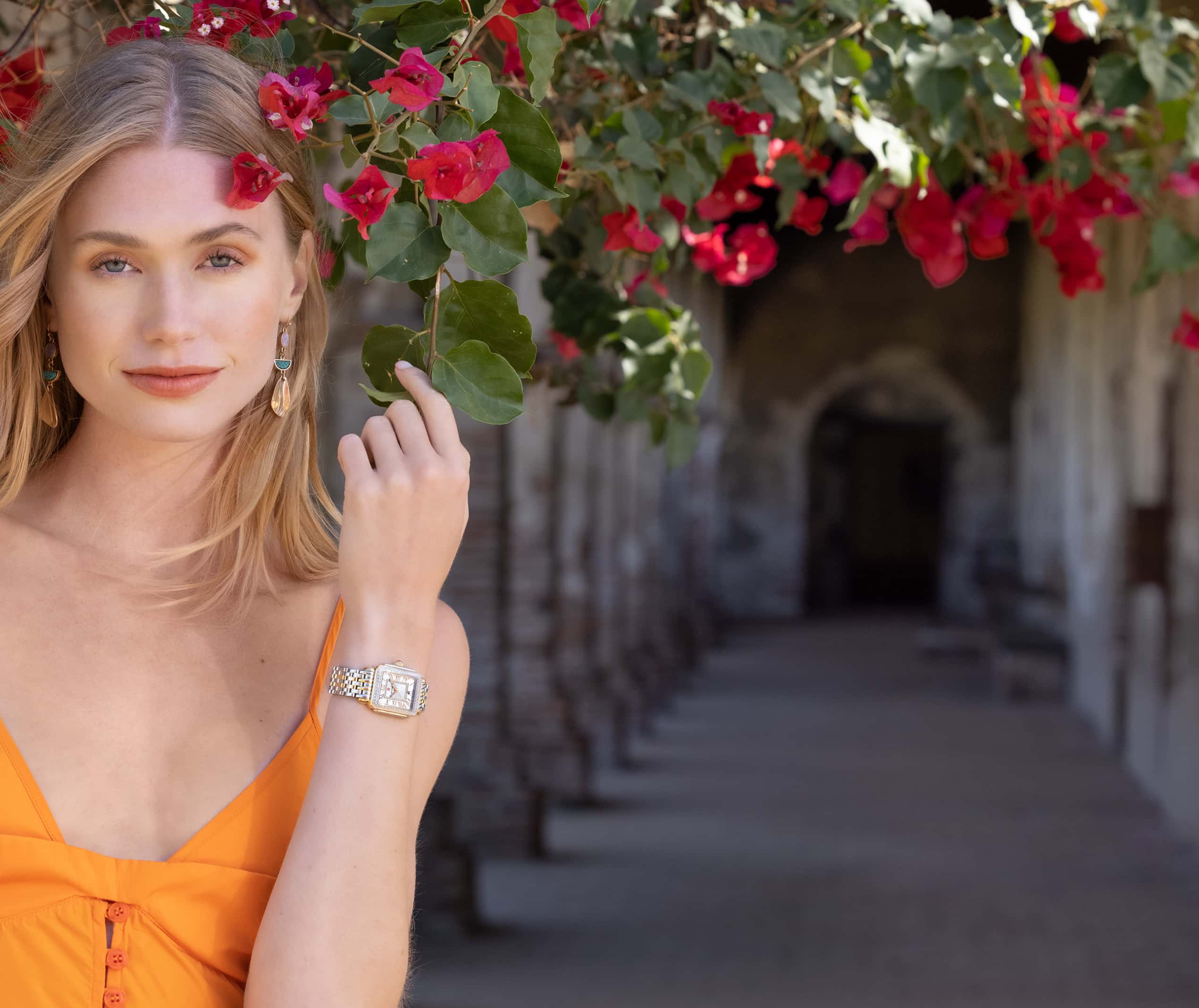 Chic woman in simple and sophisticated dress wearing two-tone stainless and 18K gold Deco Madison Mid.