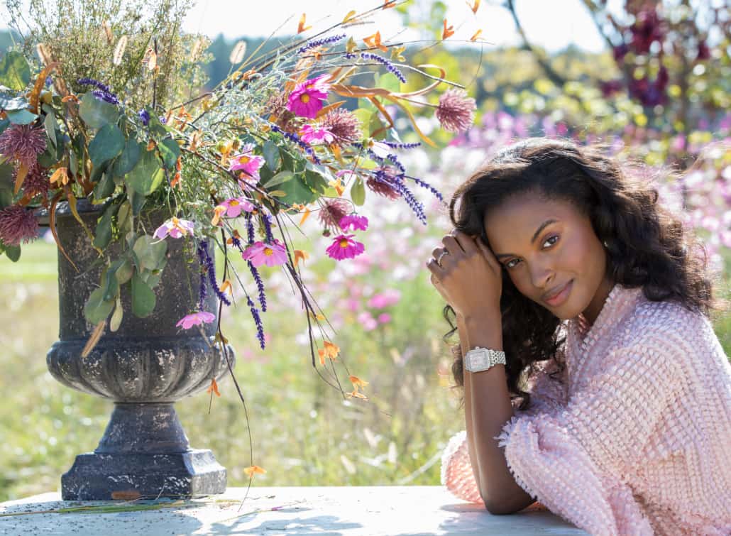 Fashionable woman in field of flowers wearing Deco Madison watch with a lilac dial.