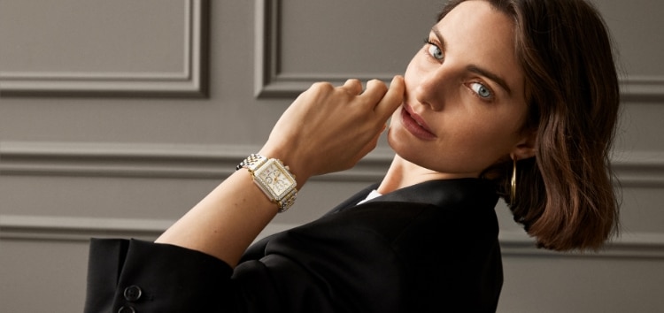 A woman wearing a Deco diamond watch in 18K gold plating