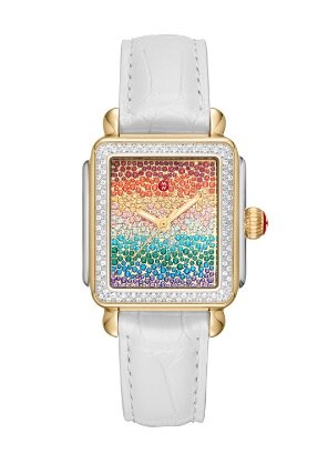 Deco Diamond carousel watch featuring a sparkling rainbow topaz dial, diamond-covered bezel, 18k gold case and white leather strap.