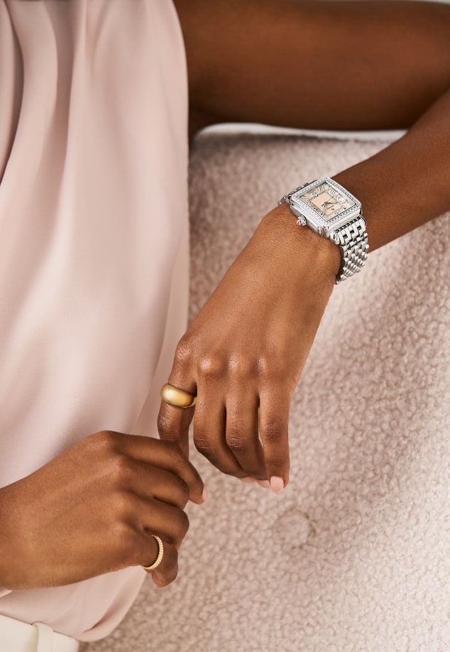 A woman wearing the Deco Madison Diamond Stainless Steel watch with an apricot mother-of-pearl dial