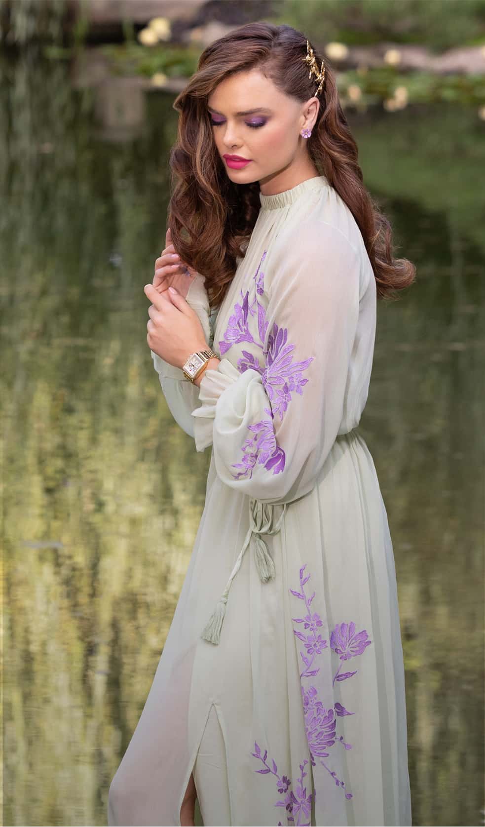 Woman in a green and purple floral gown.