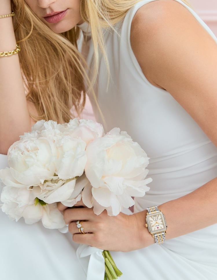 A woman wearing the Deco Madison Diamond Two-tone 18K Gold-plated watch with a peony dial