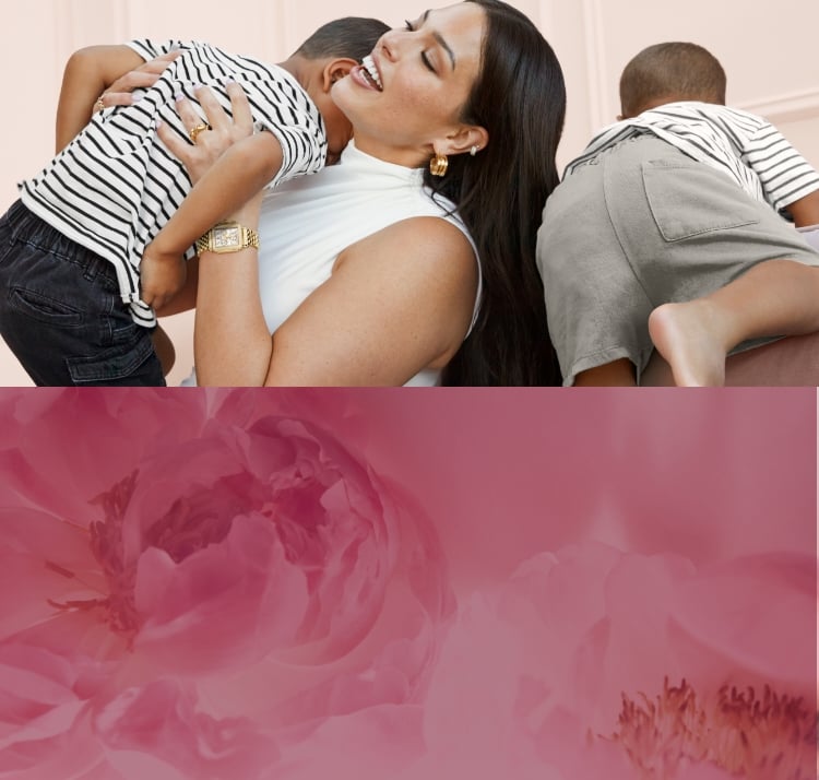 Ashley Graham wearing the Deco Diamond 18K Gold-plated watch and hugging her young son