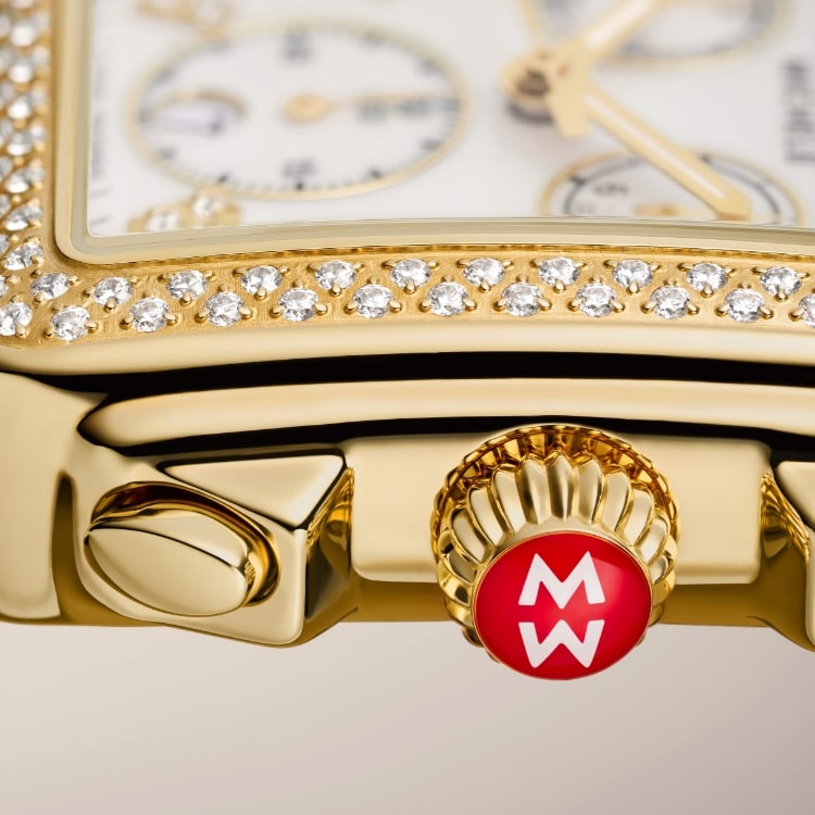 A closeup of the MICHELE signature red crown with the MW logo