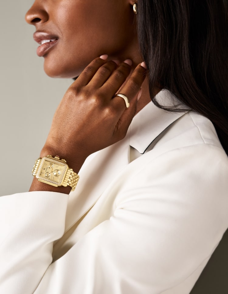 A woman wearing the Deco Diamond High Shine 18K Gold-plated watch