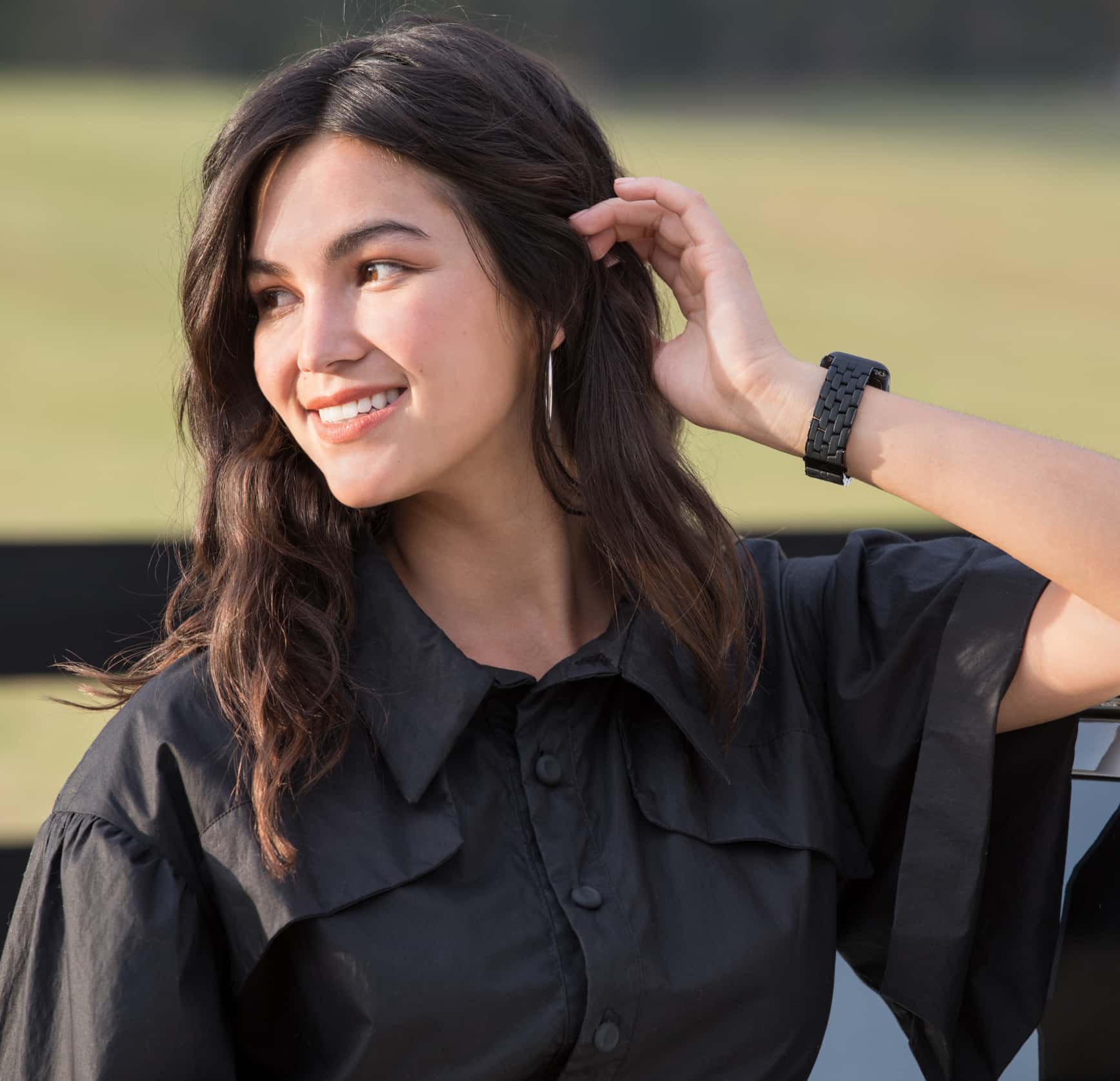 Stylish woman wearing black silicone band