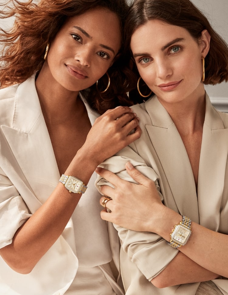 Two women wearing Deco diamond watches