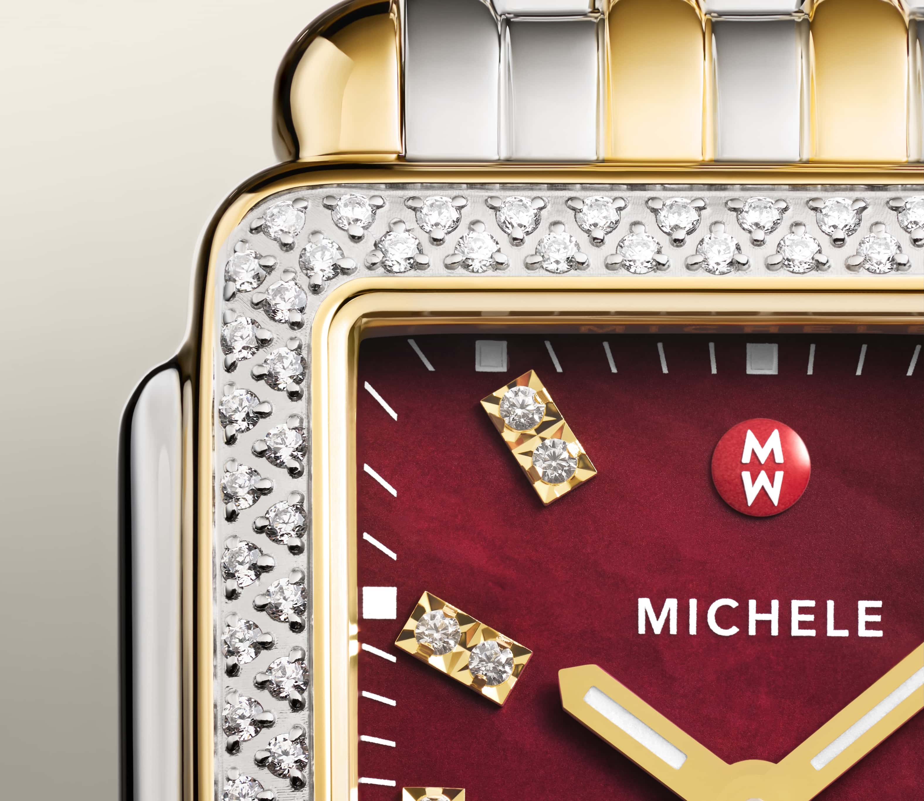 Detail shot of Deco Mid Ruby watch in two-tone with a ruby red face and double diamond indexes