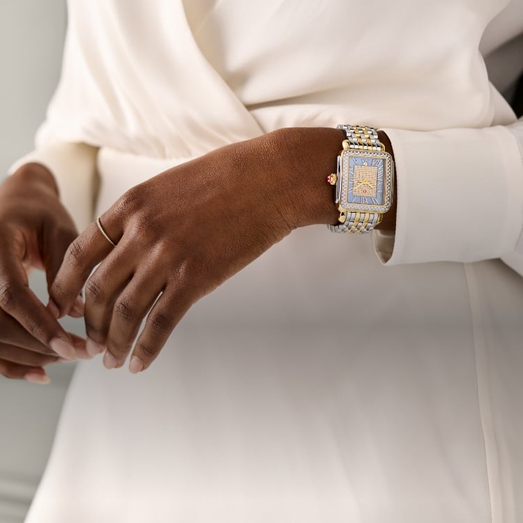 A woman wearing the Limited Edition Deco Madison Blue Dusk Pavé Two-tone 18K Gold-plated watch 