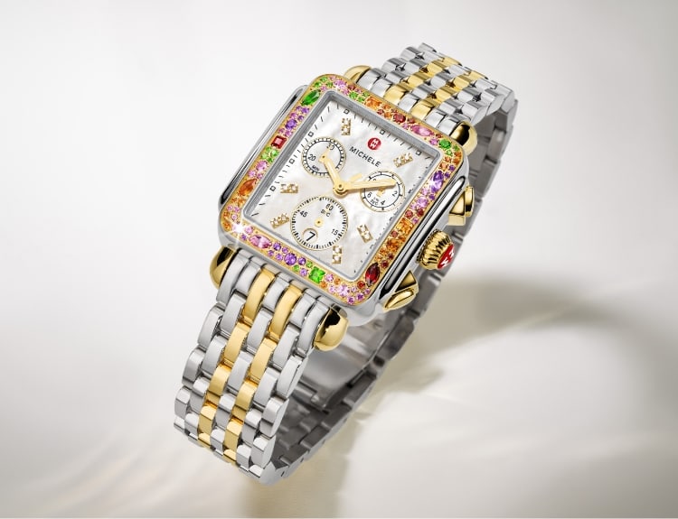 Two women wearing MICHELE watches.