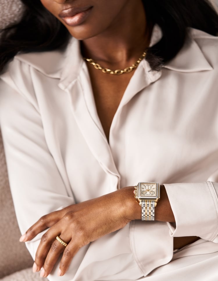 A closeup of a woman's wrist wearing the Deco Mid Diamond Two-tone 18K Gold-plated watch