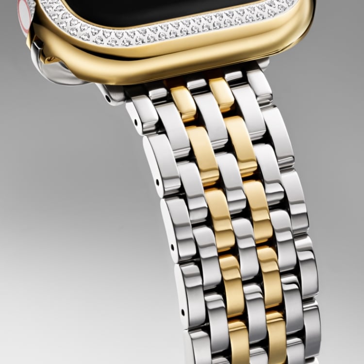 Close up of the two-tone 18K gold-plated seven-link bracelet band and two-tone 18K gold-plated diamond case for Apple Watch® 