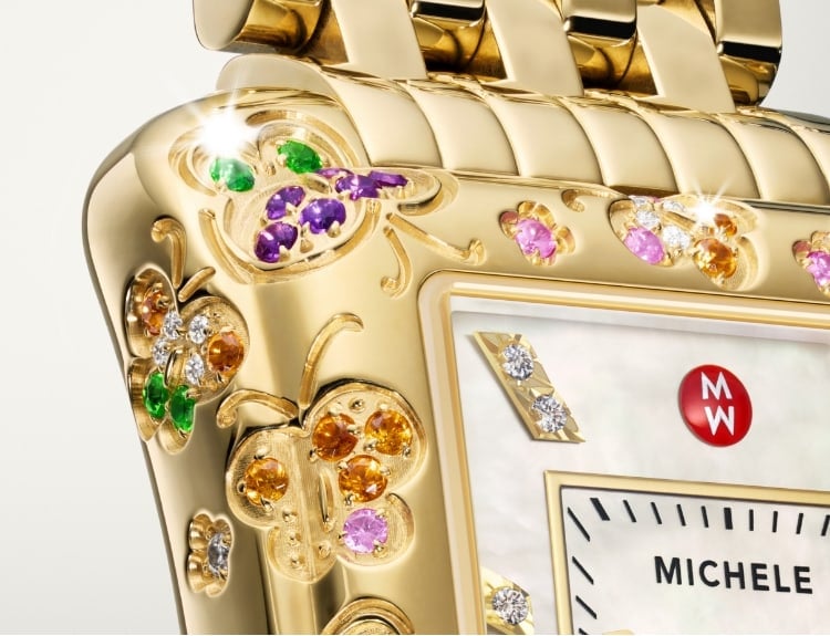 Woman wearing a MICHELE watch.