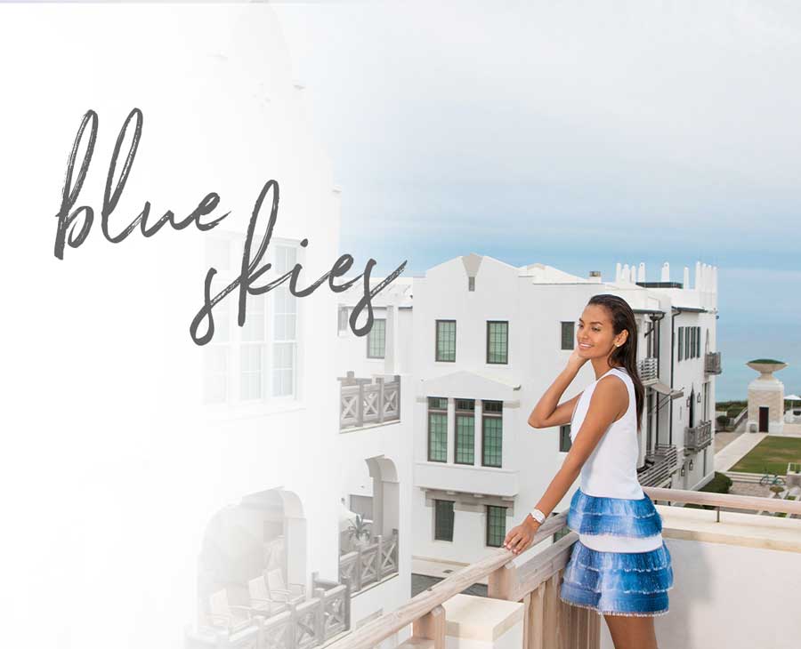 Fashionable woman standing in scenic beach town wearing a stainless Deco watch.