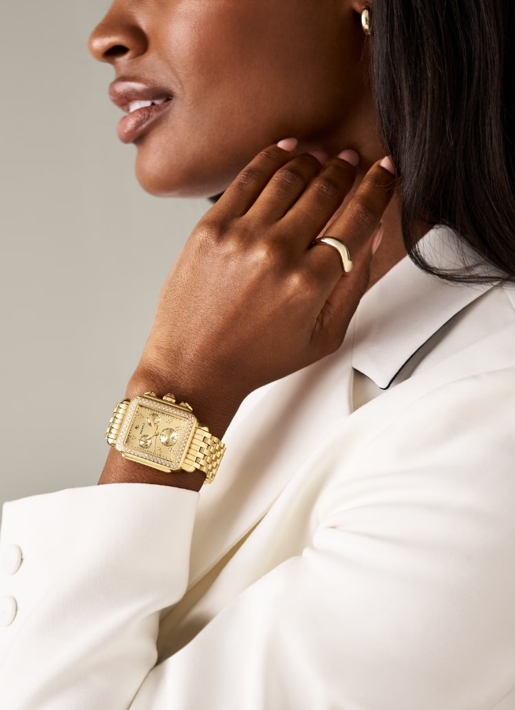 A woman wearing the Deco Diamond High Shine 18K Gold-plated watch