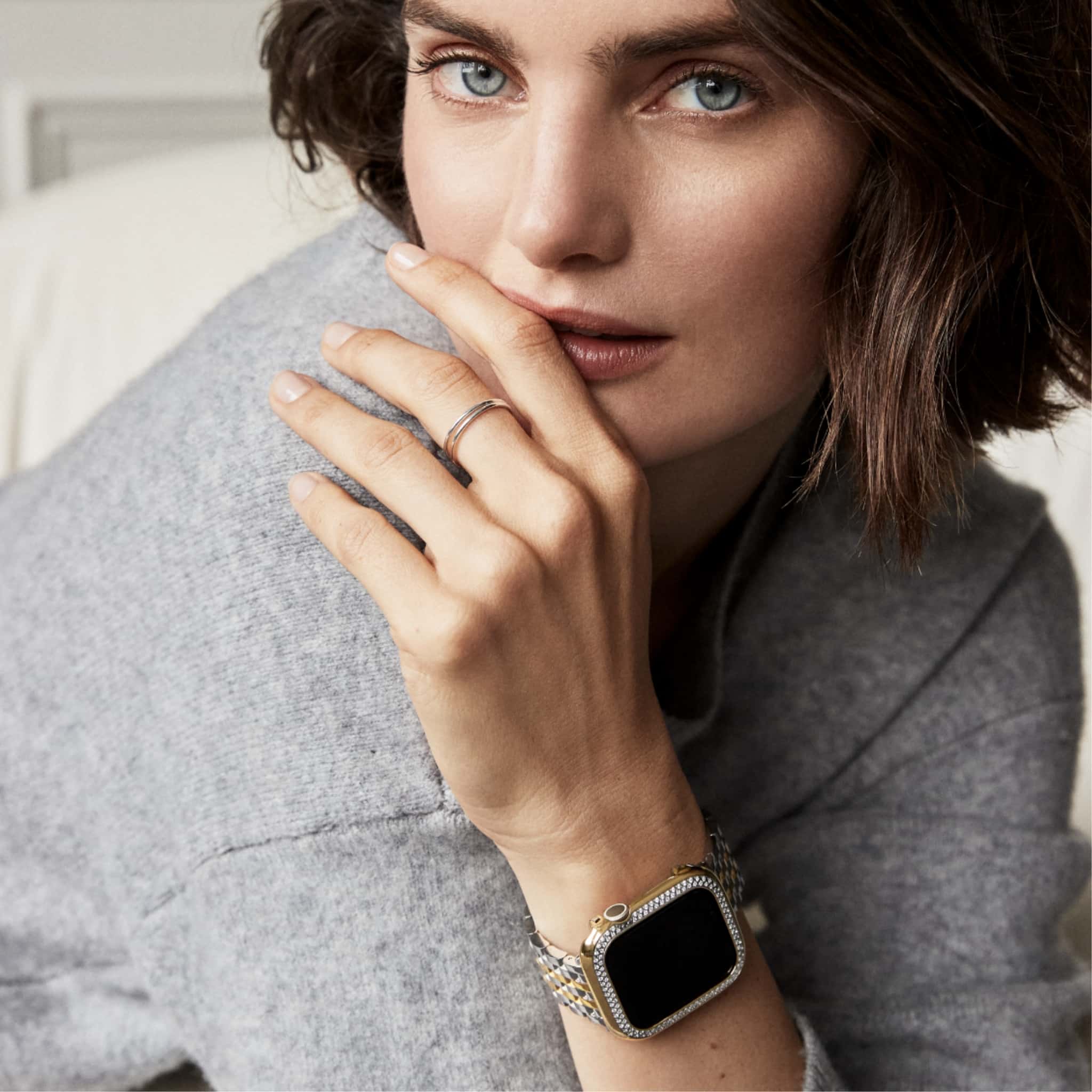 Woman wearing a MICHELE case and bracelet for her Apple Watch